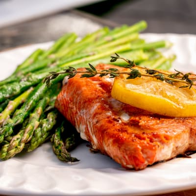 Grilled salmon and asparagus, with a lemon garnish plate at Vintage Hills of Indianola in Indianola, Iowa