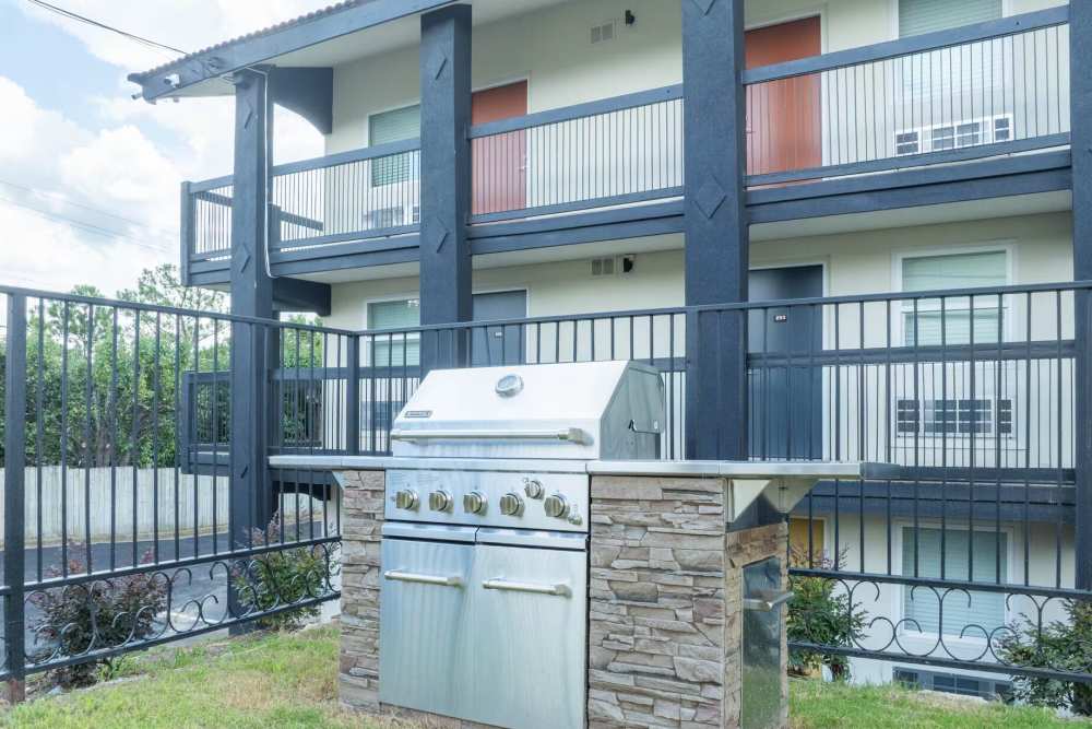 Grilling Area with Fence Facing Apartment Building  at Broadview Apartments in Columbia, South Carolina