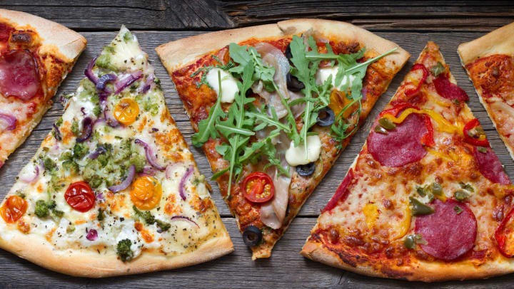 Five different slices of pizza on a wooden table | Pizzerias in The Woodlands