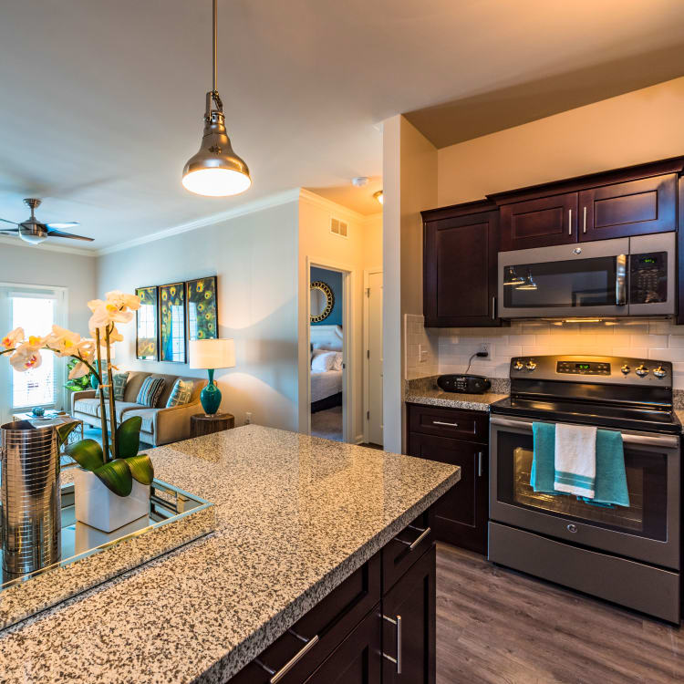 Partial view of kitchen and living area in open-concept floor plan of model home at Valley Farms in Louisville, Kentucky