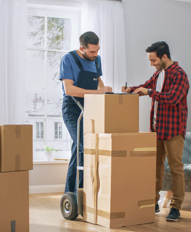 A mover helps a man get his stuff ready for storage at Seaport Storage in Tampa, Florida