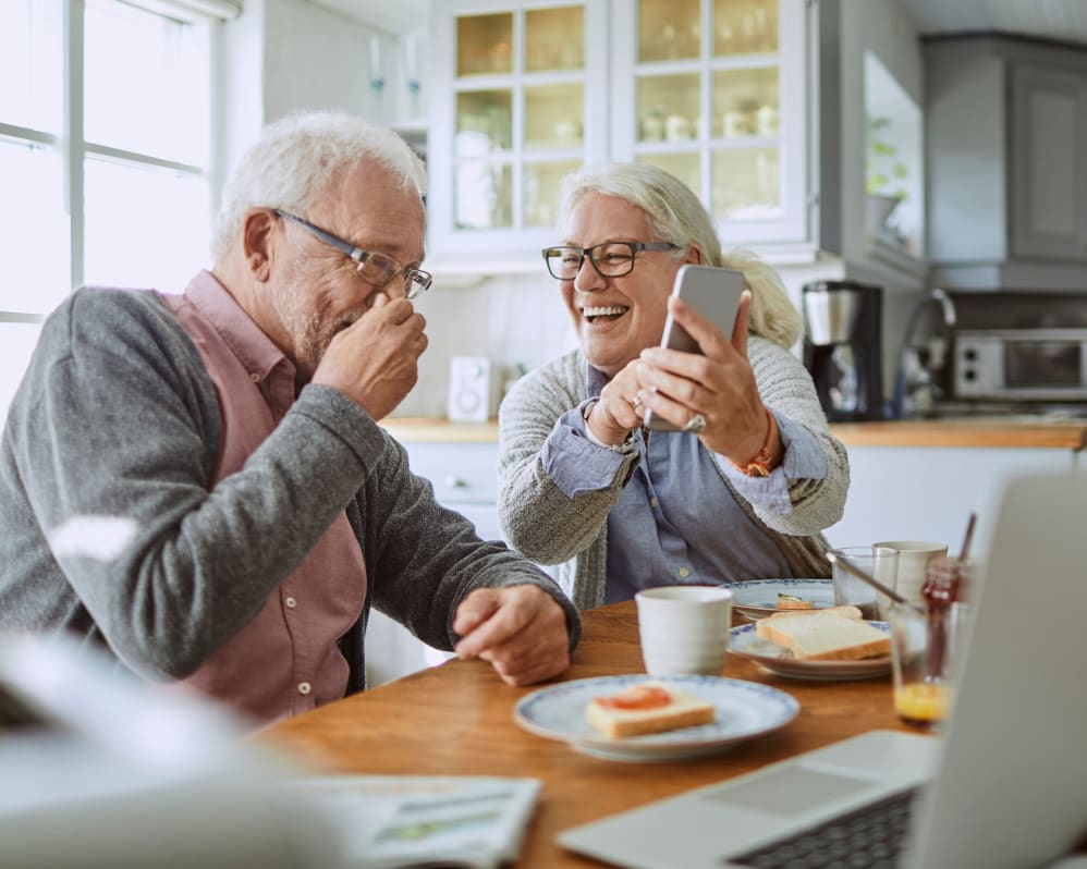 Residents laughing together during breakfast at Anthology of Tuckahoe in Henrico, Virginia