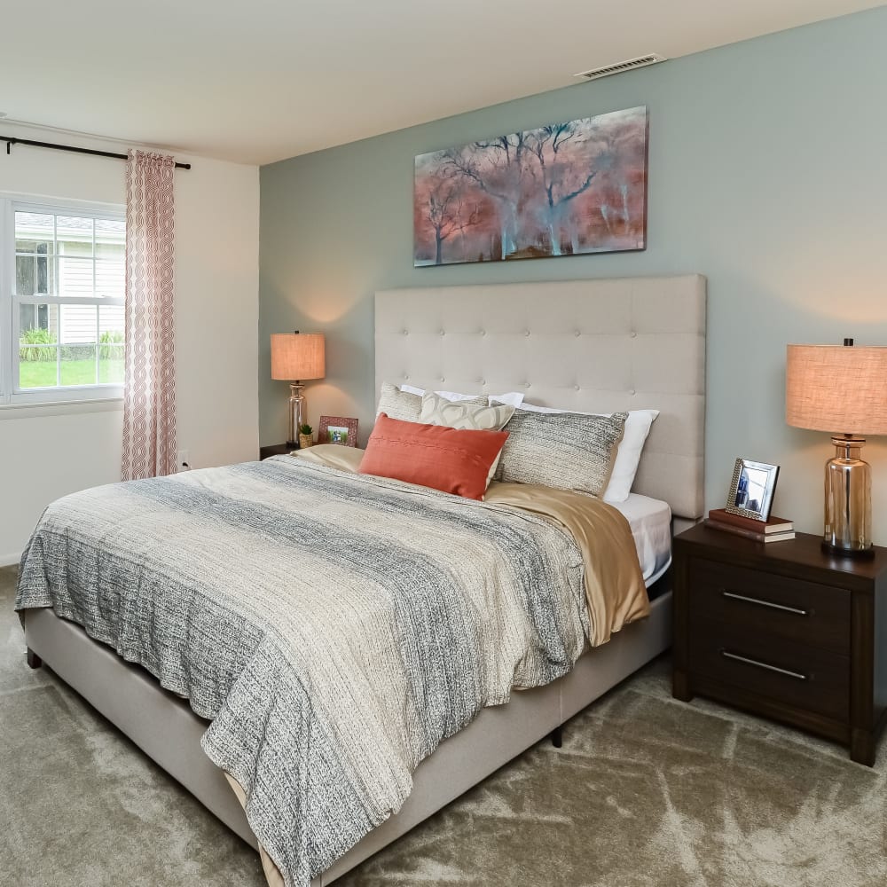 Model bedroom with plush carpeting at Raintree Island Apartments in Tonawanda, New York