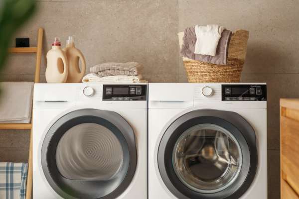Washer and dryer combo installed in a bathroom for convenient use at Prosper 83 in Sparks, Nevada