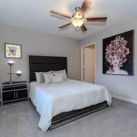 A furnished bedroom with a ceiling fan at Ten68 West in Dallas, Georgia