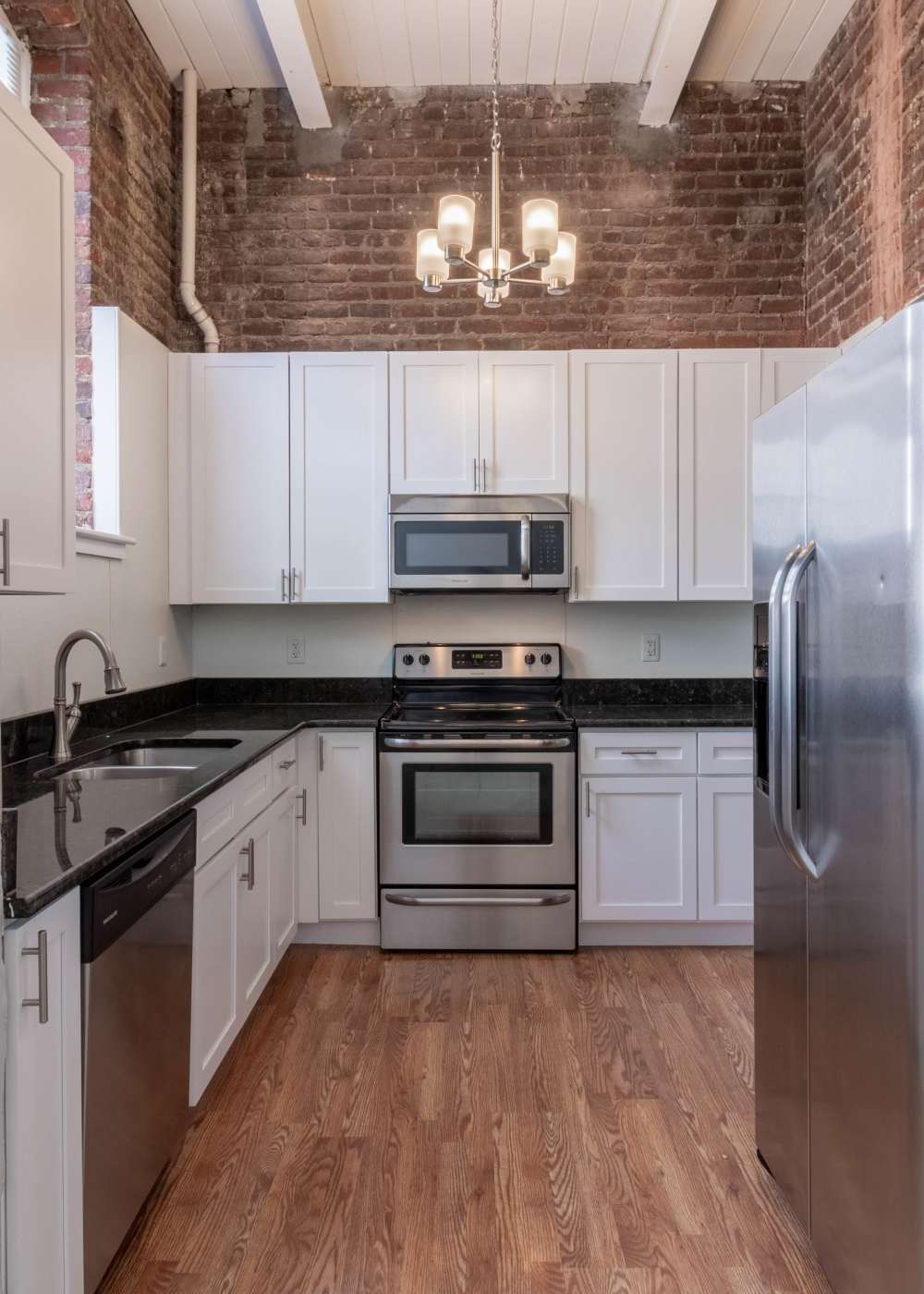 Kitchen apartment with white cupboards at Broadway Apartments in Richmond, Virginia