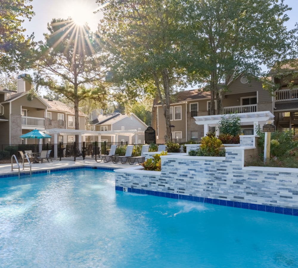 A sparkling swimming pool with a water fountain at Gates at Jubilee in Daphne, Alabama