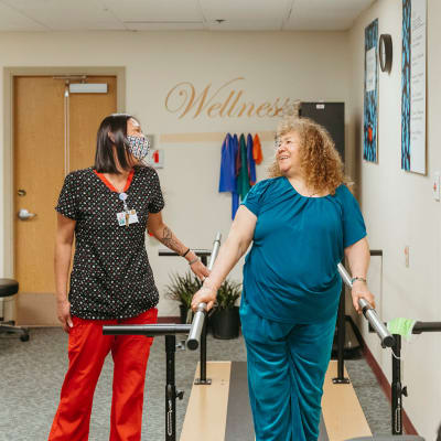Licensed nurse helping a resident with physical therapy at Cascade Park Vista Assisted Living in Tacoma, Washington