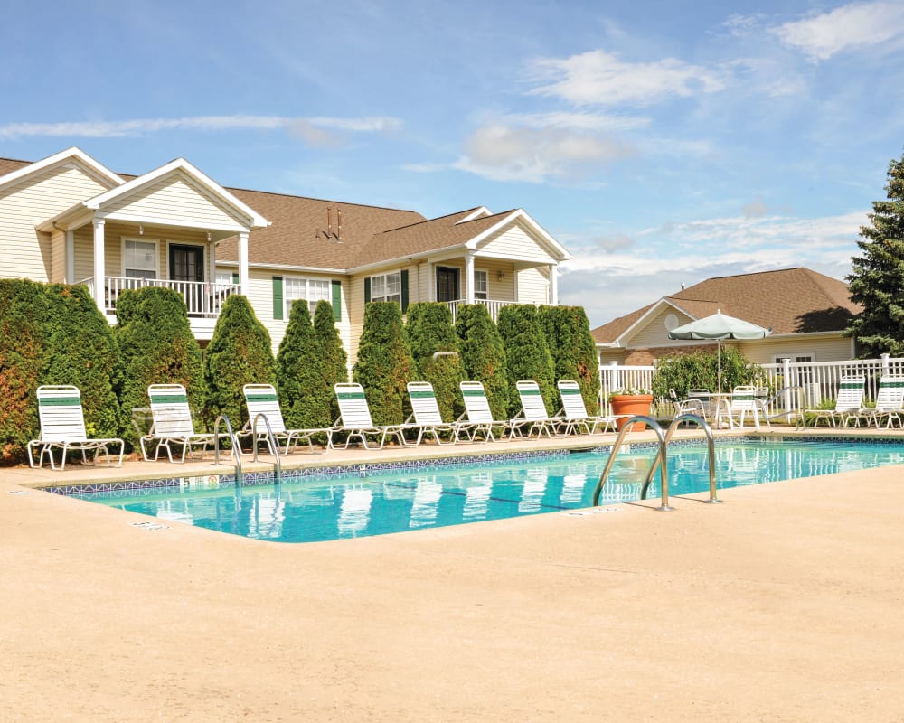 Sparkling swimming pool with an expansive sundeck and lounge chairs at The Lakes of Beavercreek in Beavercreek, Ohio