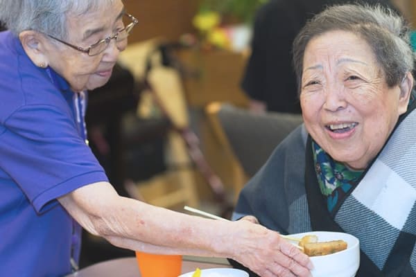A caretaker with a resident at Nikkei Manor in Seattle, Washington