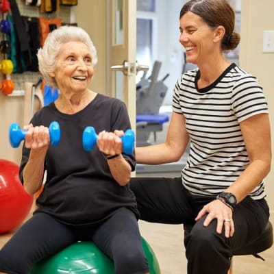 Resident with physical therapist at AgeWell Living