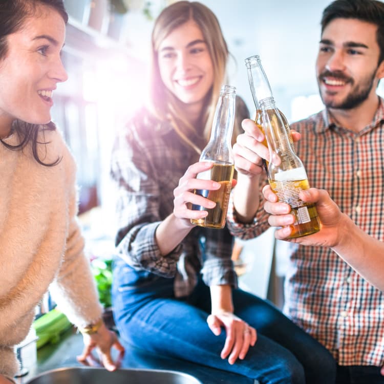 Friends cheering with bottles at Ocean Harbor Apartments