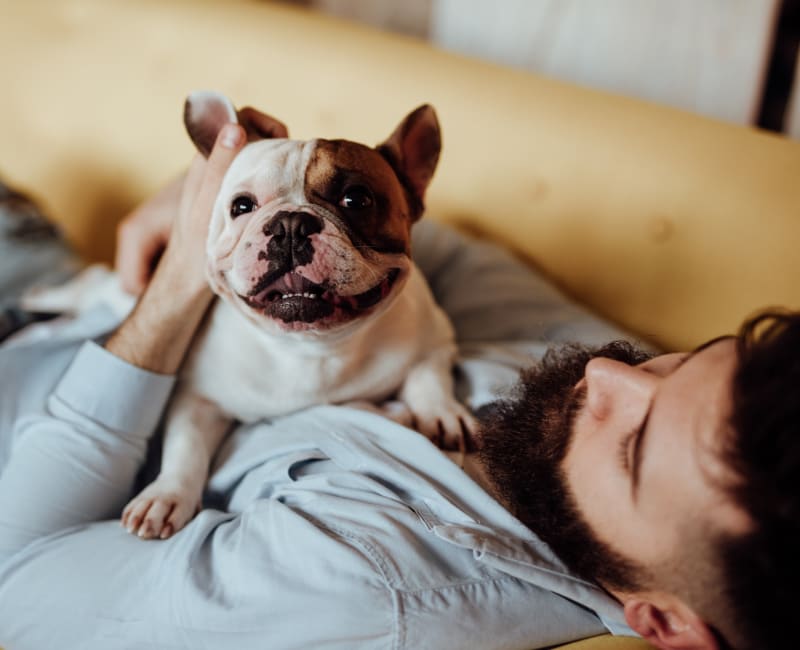 Resident and his pup relaxing in their new home at Reserve at Pebble Creek in Plano, Texas