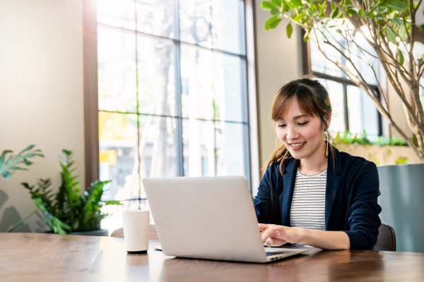 Woman working on her laptop at a cafe near BB Living at Lakewood Ranch in Lakewood Ranch, Florida