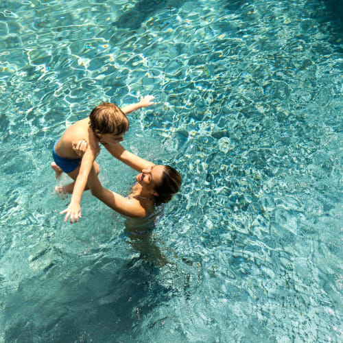 Residents playing in a swimming pool at Bart Plaza in Castro Valley, California