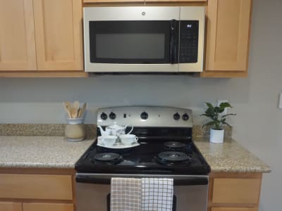 Kitchen with overhead microwave and electric stove at Amador Heights in Concord, California