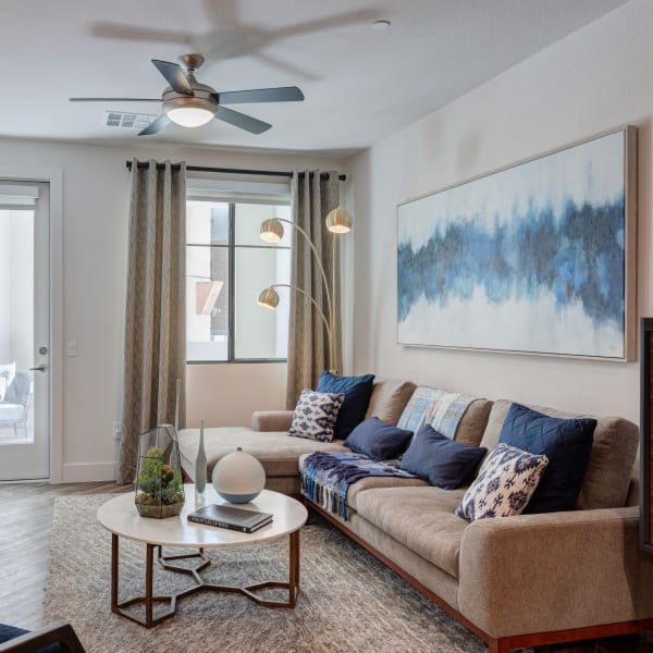 Spacious and well lit living room with a ceiling fan at The Scottsdale Grand in Scottsdale, Arizona