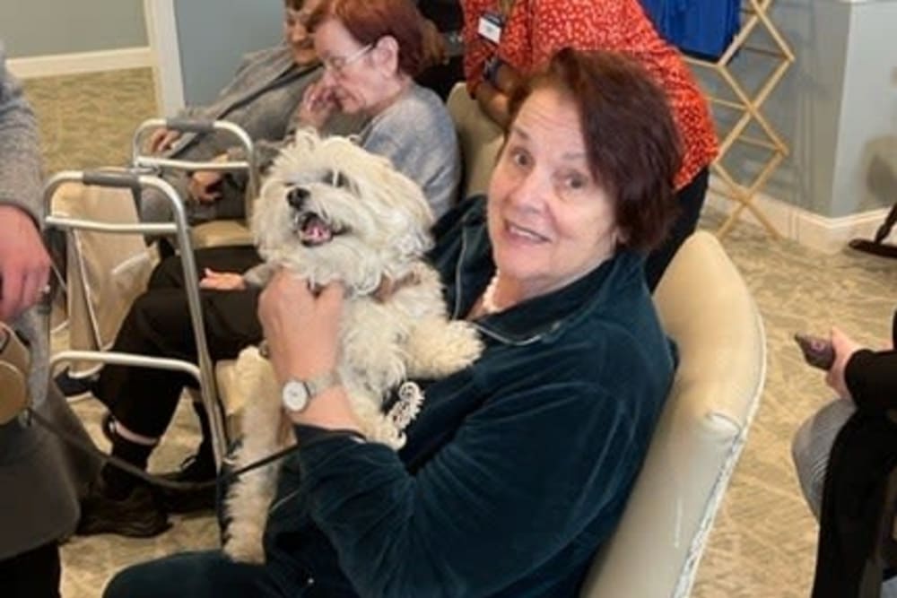 Resident with therapy dog at The Pinnacle in Plymouth Meeting, Pennsylvania