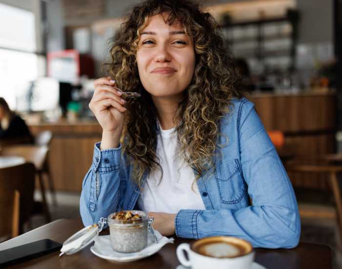 Resident woman enjoying coffee in a nearby cafe at Falls Creek in Sanford, North Carolina