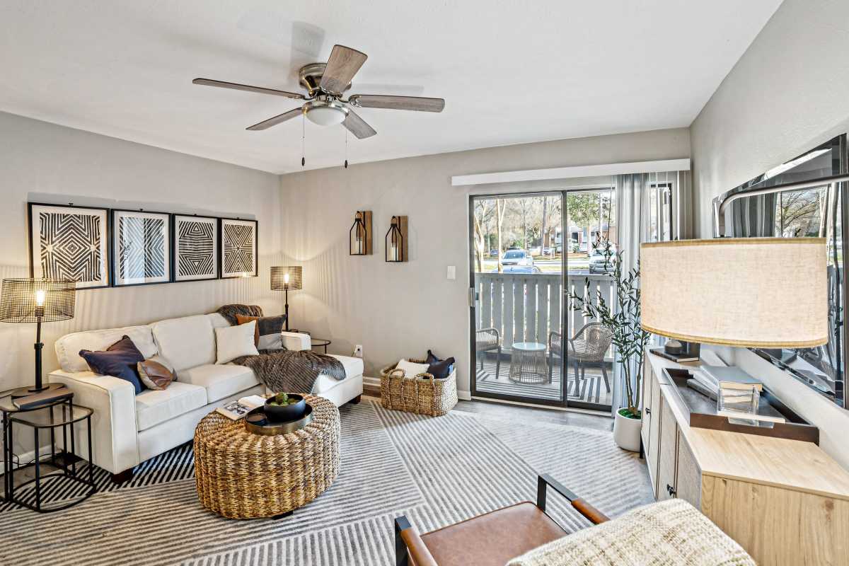 Resident living space with wood-style flooring at Lakes at Lincoln in Greensboro, North Carolina