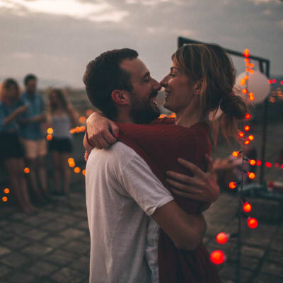 Resident couple holding each other on a roof top near Landmark Apartments Phase II in Little Rock, Arkansas