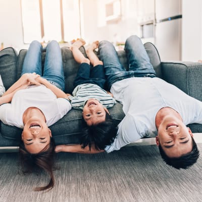 A resident family laying upside down on a couch in a home at Bellevue in Washington, District of Columbia