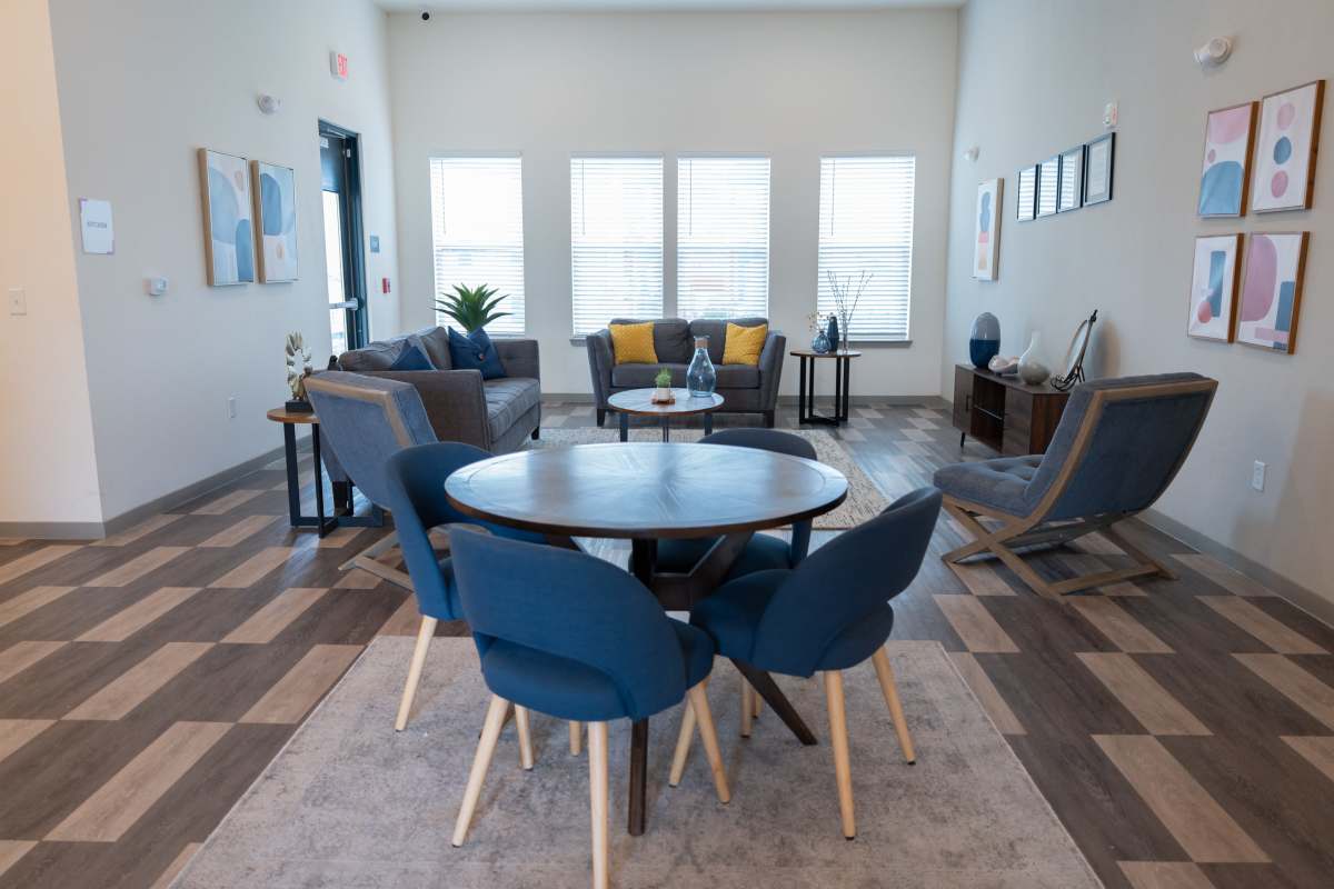 Cute puppy seating on couch in pet friendly apartment at Estates At Rockwell in Oklahoma City, Oklahoma