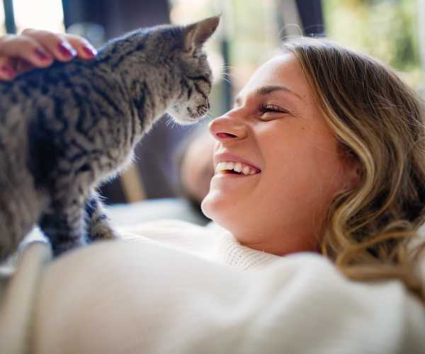 Resident woman pampering her cat at The Abbey at Briargrove Park in Houston, Texas