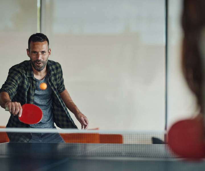 Residents in the clubhouse playing in the game room at Devonwood Apartments in Fayetteville, North Carolina