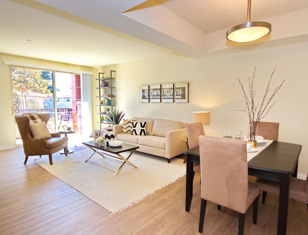Model home living room with hardwood floors and plenty of natural light at IMT Townhomes at Magnolia Woods in Sherman Oaks, California