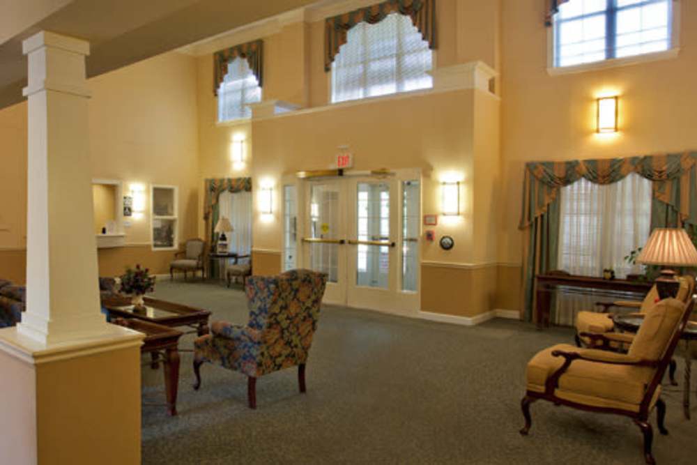 Community lobby area with chairs at The Willows Senior Community in Bowie, Maryland