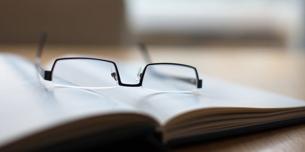 Reading glasses sitting on a book at The Springs at Wilsonville in Wilsonville, Oregon