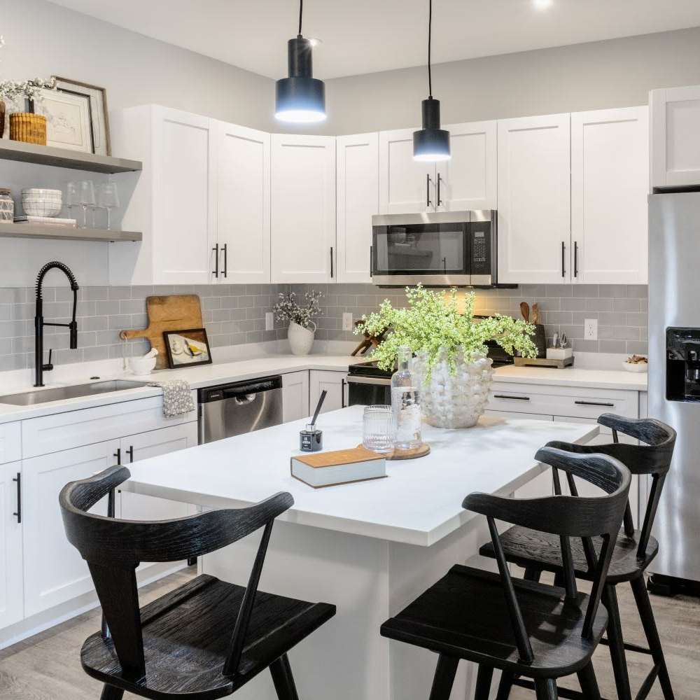 Modern kitchen with stainless-steel appliances, island countertop and barstool at InterUrban 2.0 in Billings, Montana