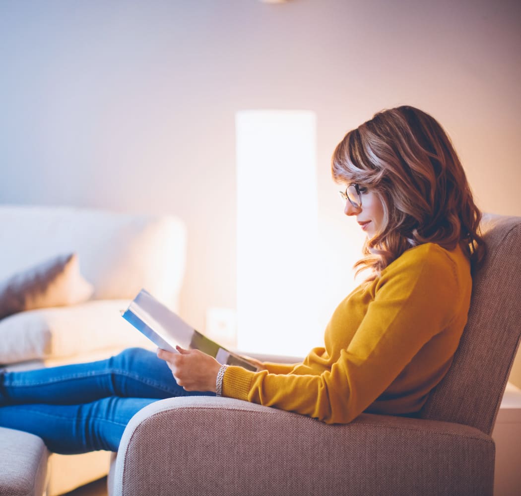 Woman reading a book at One Eton Square in Tulsa, Oklahoma