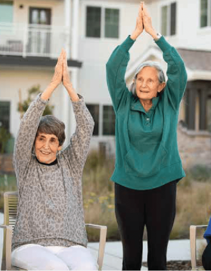 Residents in an outdoor yoga class at Clearwater at The Arboretum in Austin, Texas