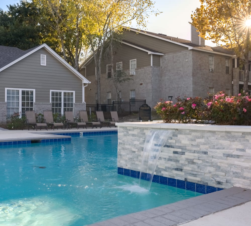 A sparking swimming pool with a waterfall fountain at Lenox Gates in Mobile, Alabama