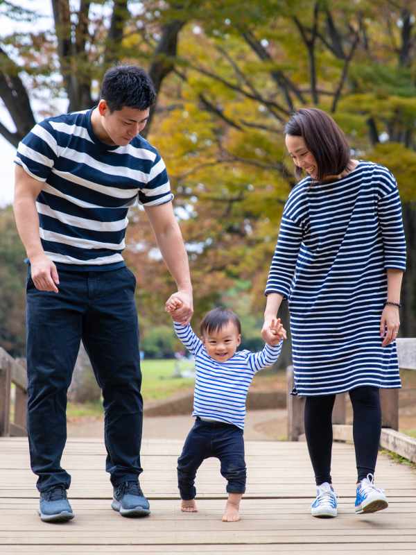 Residents with their kid walking in the park near The Courtney at Lake Shadow in Orlando, Florida
