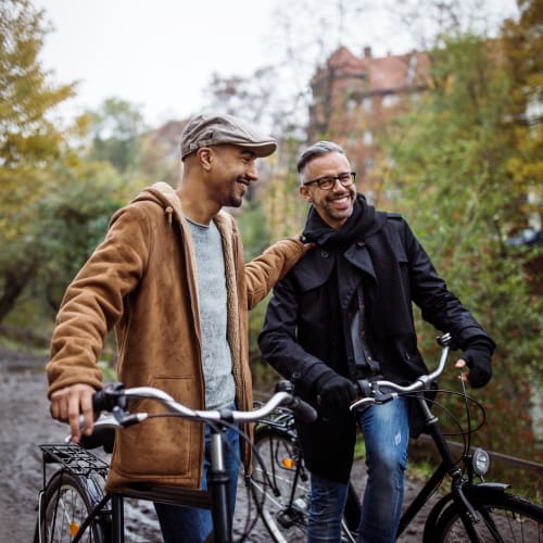 Friends chatting and walking their bikes near Spokane at Rainier Court in Seattle, Washington
