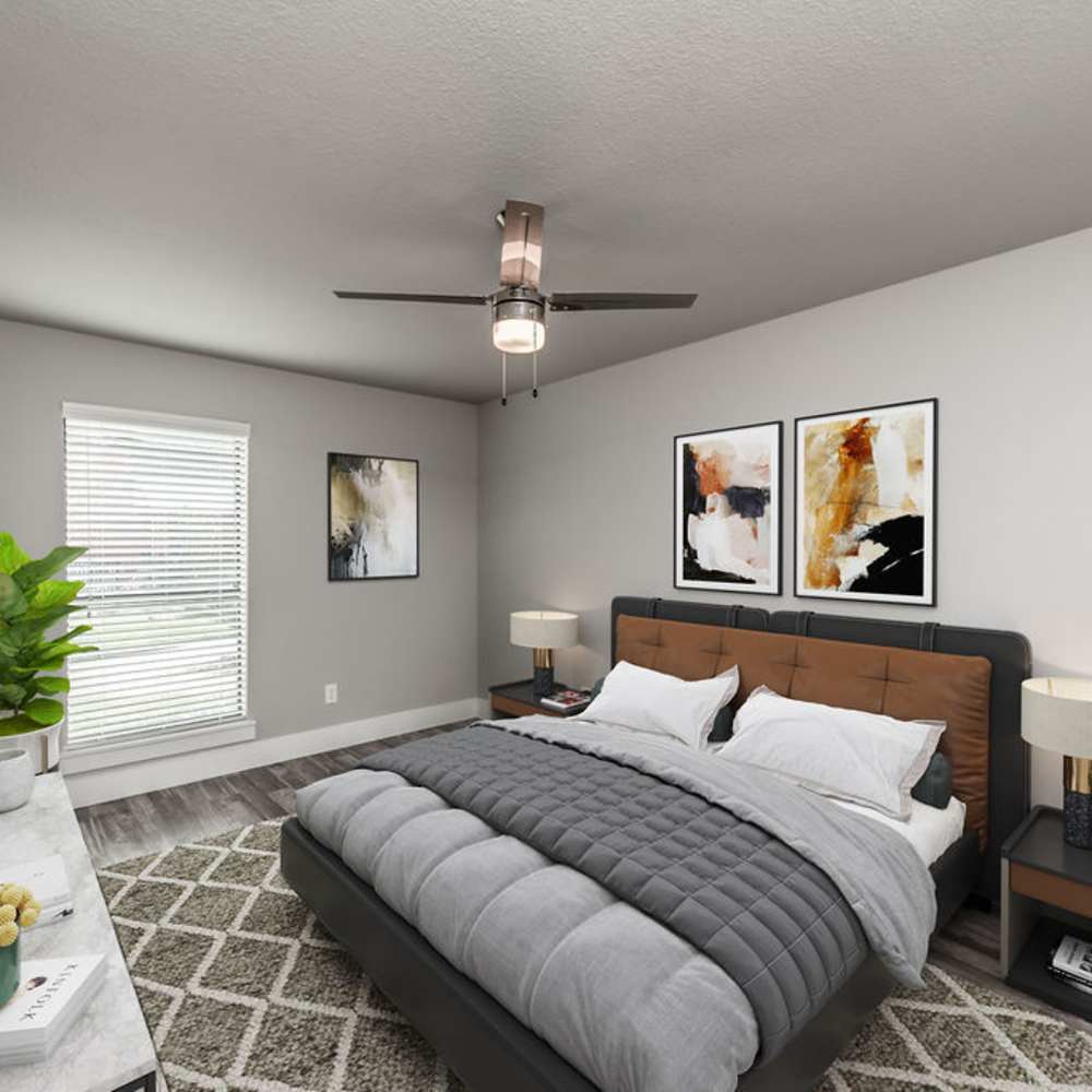 Well-lit bedroom with a window and a comfortable bed at The Brighton in Houston, Texas