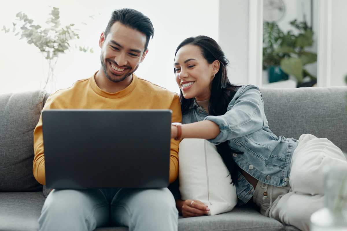 Resident couple looking at laptop at Kimberly Pointe in Houston, Texas