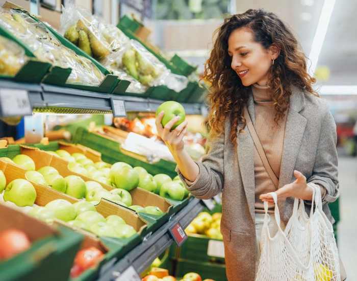 Resident woman shopping groceries in a nearby grocery store at Hudson Woods in Gastonia, North Carolina