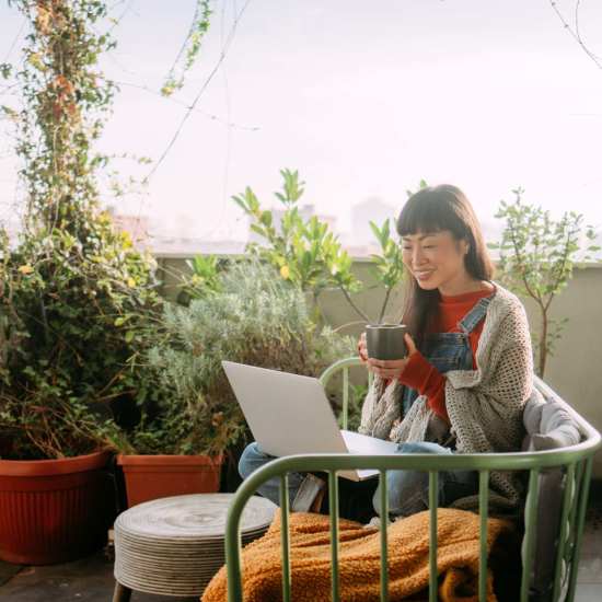 Resident working from her balcony at Middleborough Station in Middleborough, Massachusetts