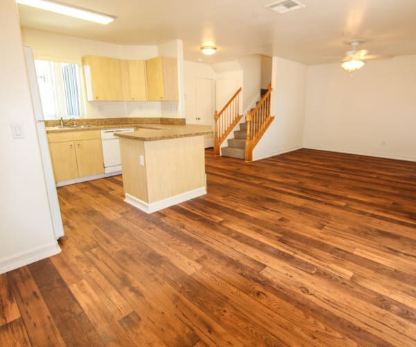 Inside a home with wood floors and an open kitchen at Vista Ridge in Vista, California