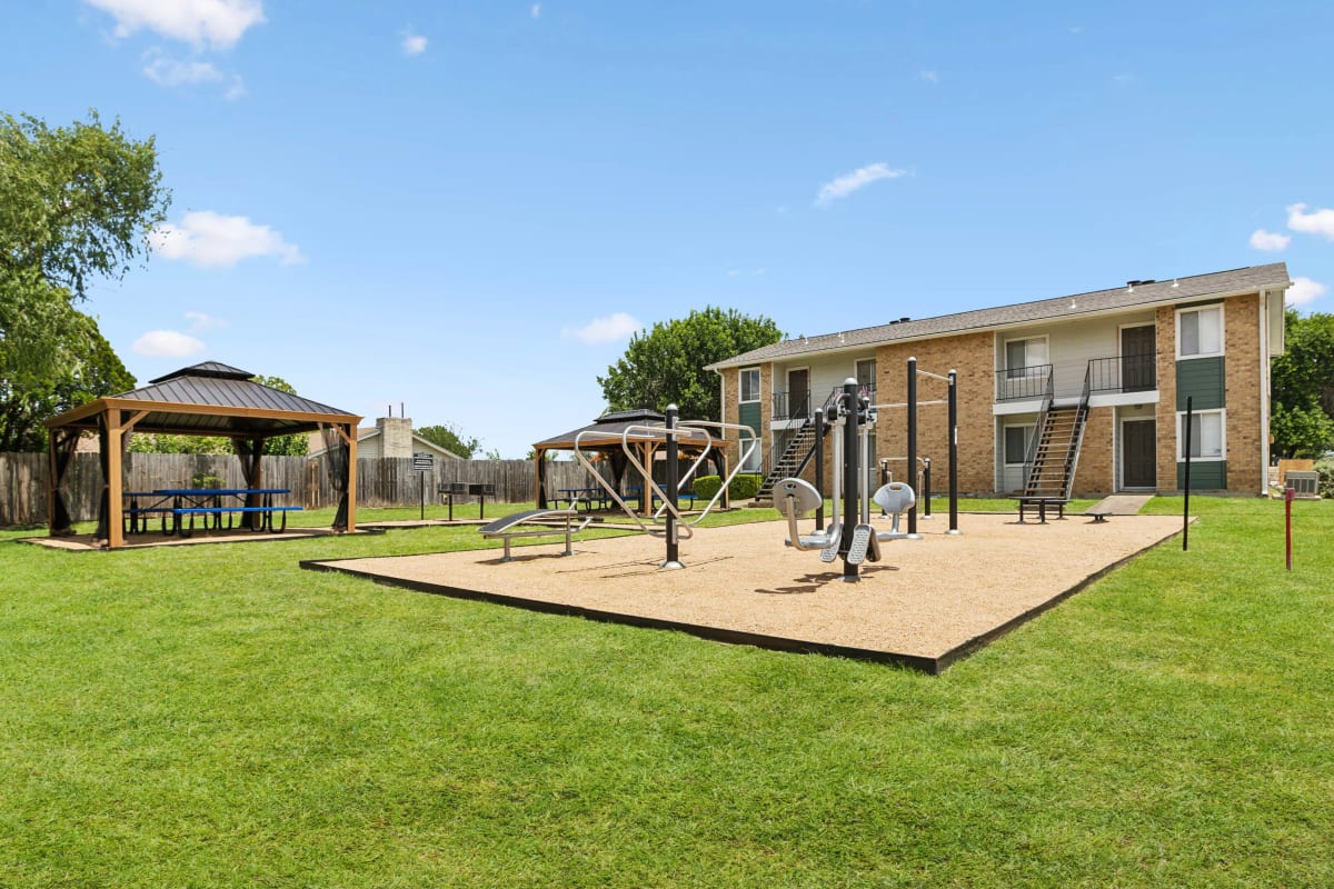Outdoor fitness area nearby seating and grills at Stonehill in Killeen, Texas