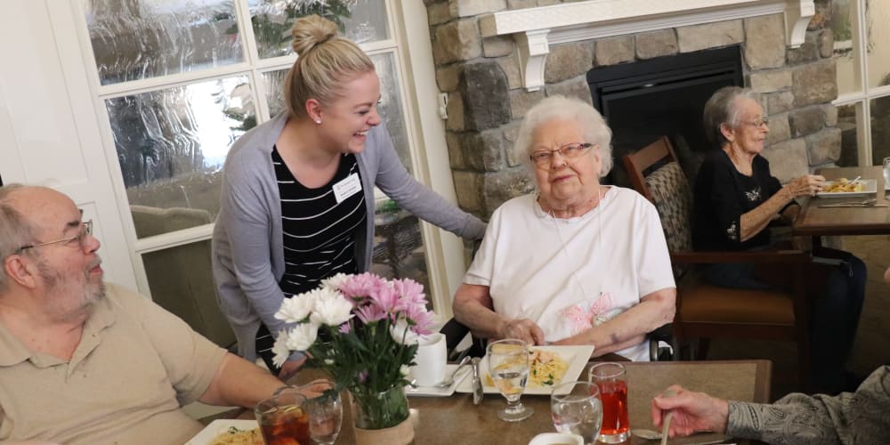 Residents dining with caregiver in background at The Springs at Grand Park in Billings, Montana
