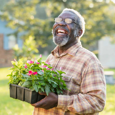 Happy resident of Deer Creek Senior Living gardening in Desoto, Texas