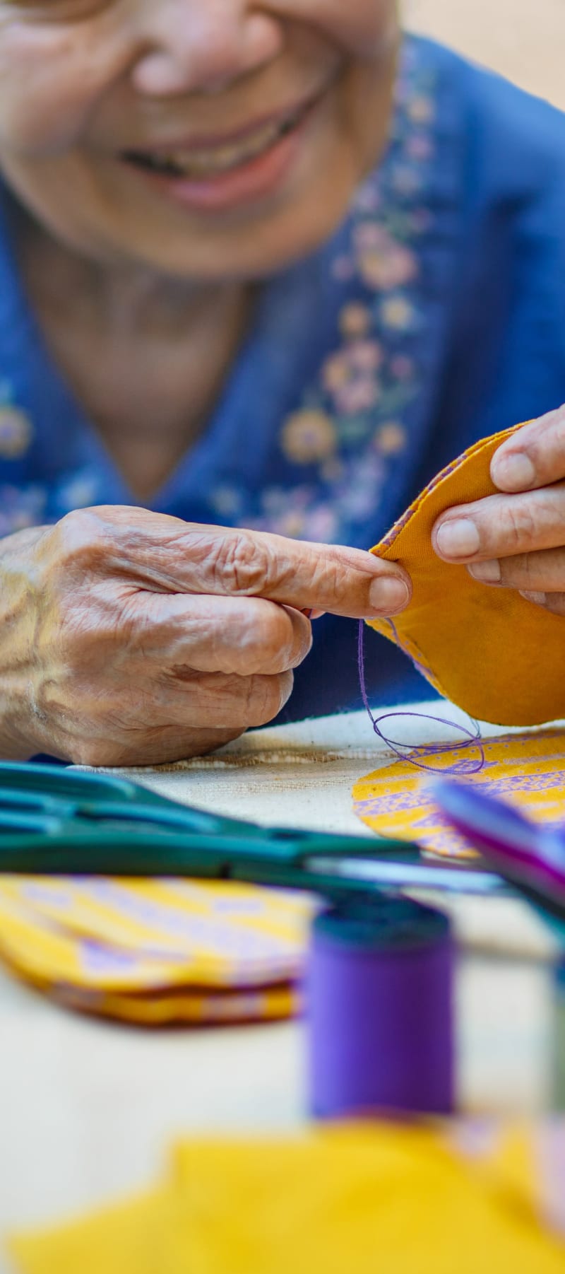 Resident sewing at East Troy Manor in East Troy, Wisconsin