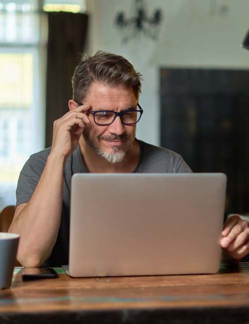 Resident on his laptop at Silvey Villas at Homestead in Dixon, California