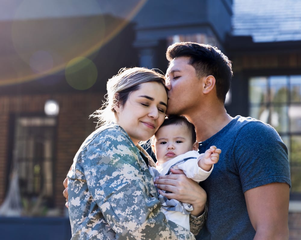 A military family standing outside at Westcott Hill in Joint Base Lewis McChord, Washington