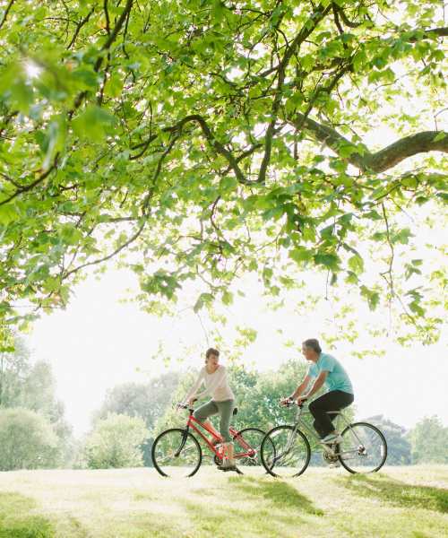 Residents riding bike near Terrace Garden Apartment Homes in San Leandro, California